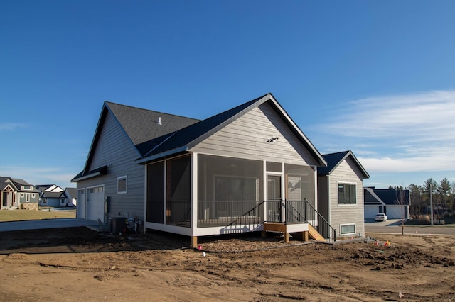 view of front of property with a sunroom and a garage