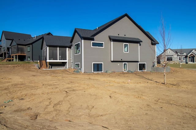 rear view of house featuring a sunroom