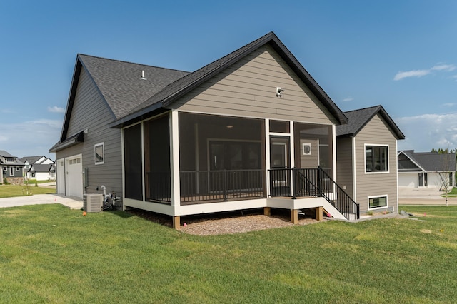 3180 Bella Terra Ln NE, Rochester, MN 55906 - rear view of house with a shingled roof, a sunroom, an attached garage, concrete driveway, and a lawn