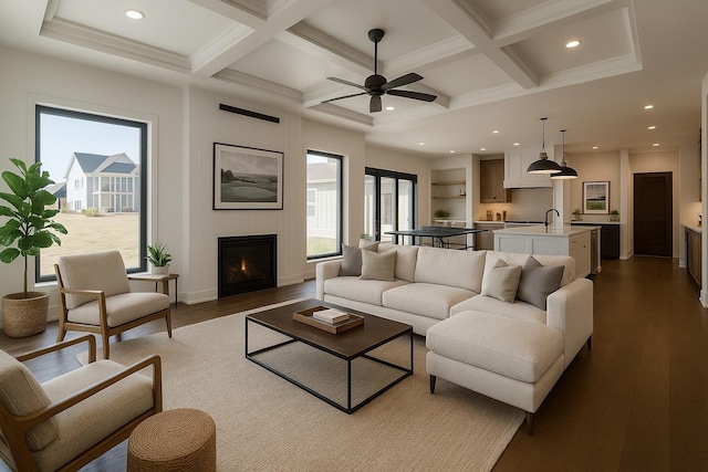 3180 Bella Terra Ln NE, Rochester, MN 55906 - living room with a fireplace, coffered ceiling, beam ceiling, dark wood finished floors, and a ceiling fan