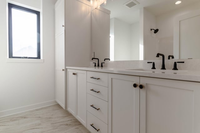 3180 Bella Terra Ln NE, Rochester, MN 55906 - bathroom with baseboards, double vanity, a shower, recessed lighting, and marble finish flooring