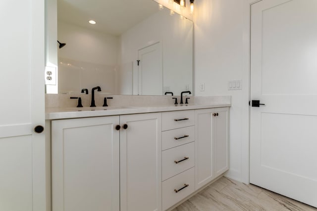 3180 Bella Terra Ln NE, Rochester, MN 55906 - bathroom featuring double vanity and marble look tiles