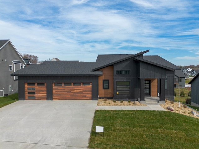 contemporary home featuring a front lawn and a garage