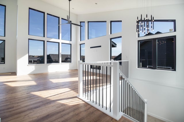 hall featuring hardwood / wood-style floors and a high ceiling