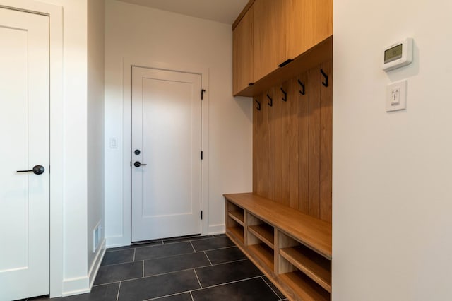 mudroom featuring dark tile patterned flooring