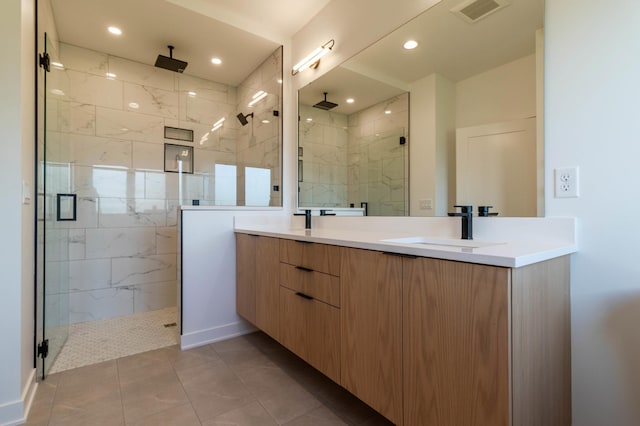 bathroom with vanity, a shower with shower door, and tile patterned flooring