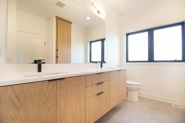 bathroom featuring vanity, toilet, and tile patterned flooring