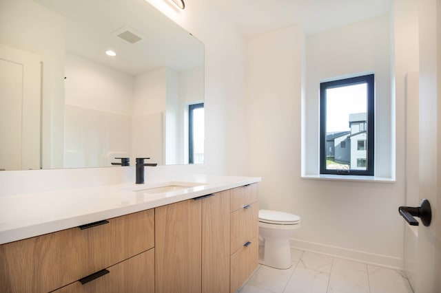 bathroom with vanity and toilet