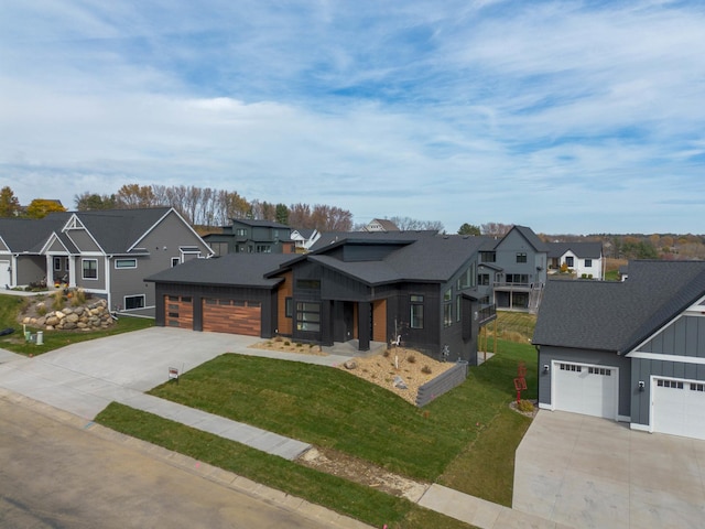 view of front of property featuring a garage and a front lawn