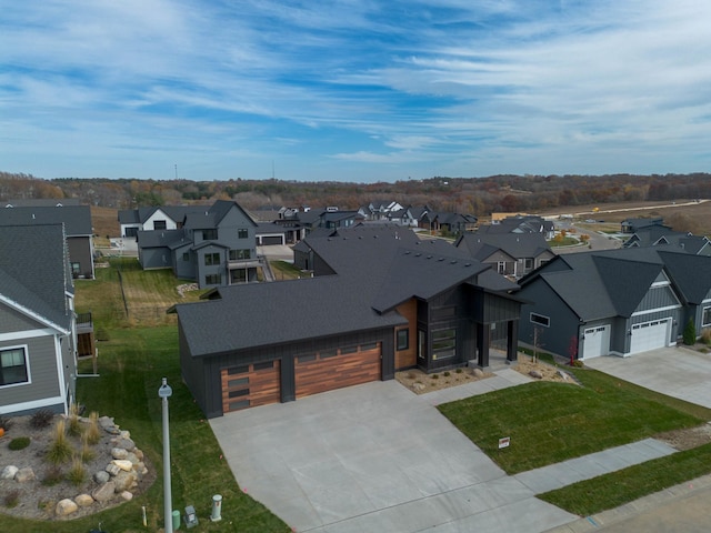 view of front of home with a garage and a front lawn