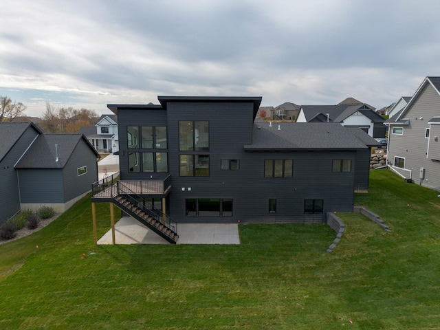 rear view of property featuring a yard and a patio