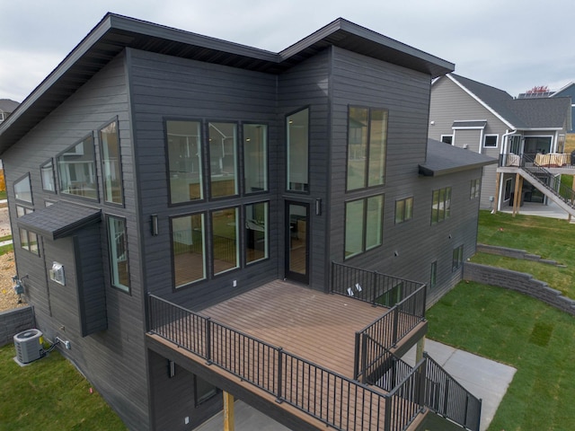 back of house featuring a yard, a deck, and central AC unit