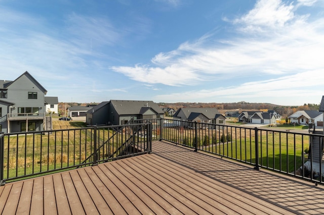 wooden terrace featuring a lawn