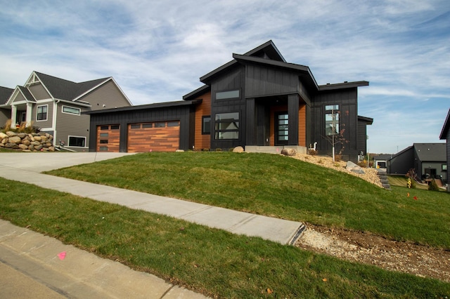 view of front of property featuring a garage and a front lawn