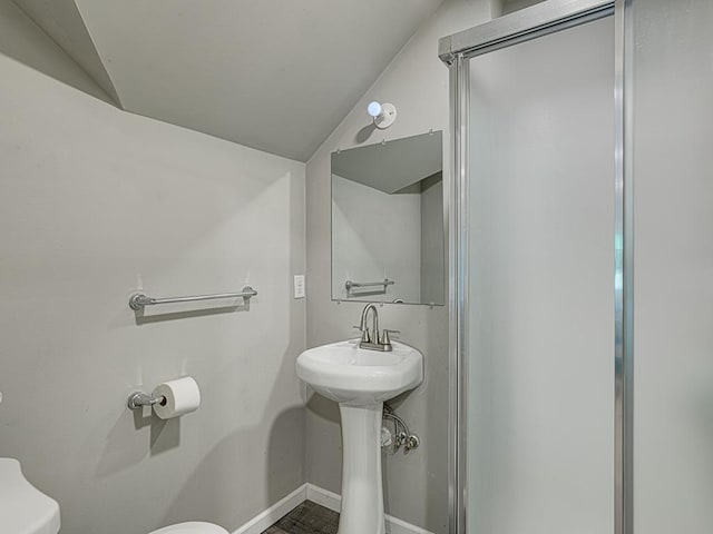 bathroom with lofted ceiling and toilet