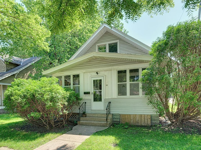 bungalow-style home featuring a front lawn