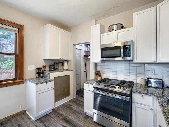 kitchen featuring dark wood-type flooring, appliances with stainless steel finishes, and white cabinets