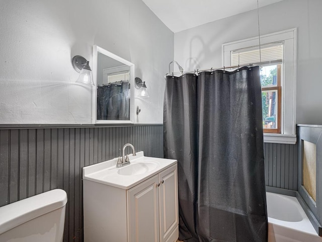 full bathroom featuring vanity, wooden walls, toilet, and shower / bath combo with shower curtain