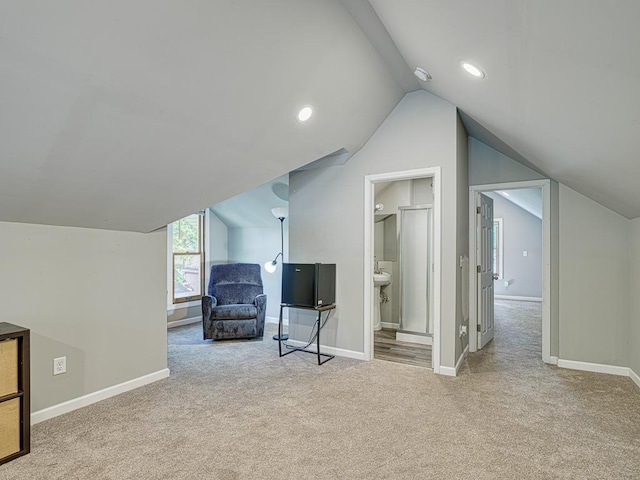 bonus room featuring lofted ceiling and light colored carpet