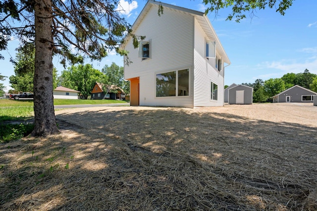 back of property featuring a storage shed