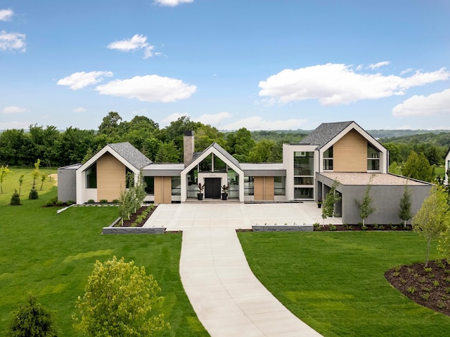 rear view of house featuring a yard