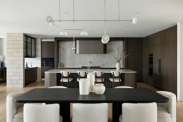 dining room featuring light hardwood / wood-style flooring and sink