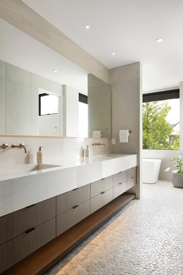 bathroom featuring a bathing tub and vanity