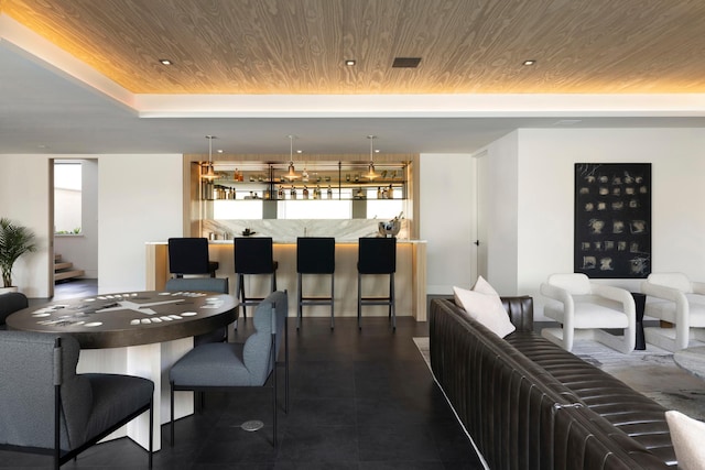 interior space featuring bar area and wood ceiling