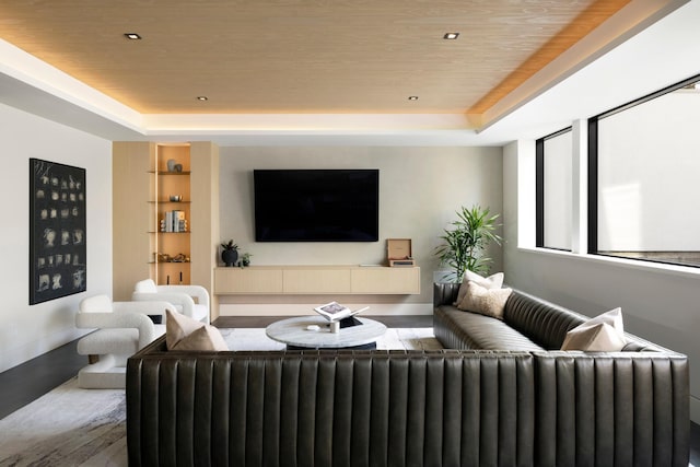 living room featuring a tray ceiling, wood ceiling, and wood-type flooring