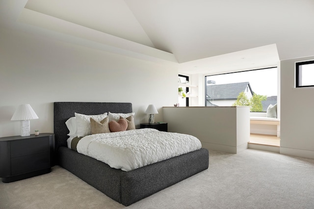 bedroom featuring light colored carpet and high vaulted ceiling