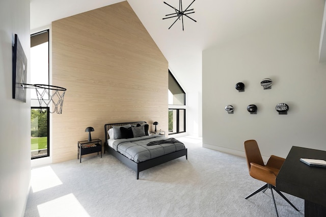 carpeted bedroom featuring a chandelier, high vaulted ceiling, and wood walls