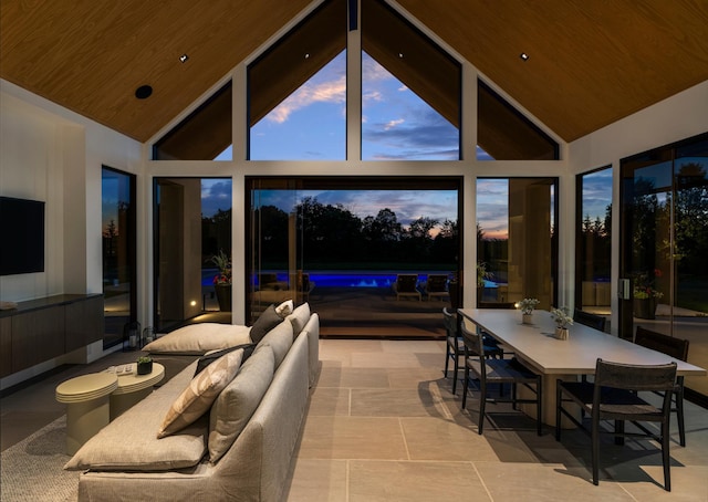 sunroom featuring lofted ceiling and wood ceiling