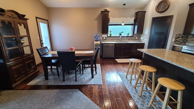 dining room featuring sink and dark hardwood / wood-style floors