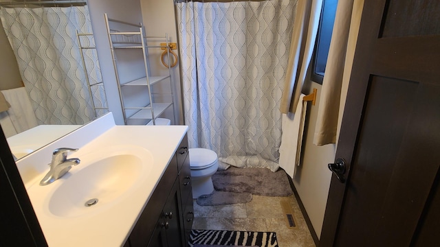 bathroom featuring vanity, tile patterned flooring, and toilet