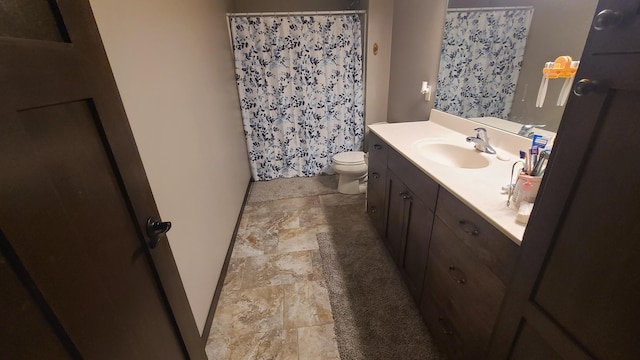 bathroom with tile patterned flooring, toilet, and vanity