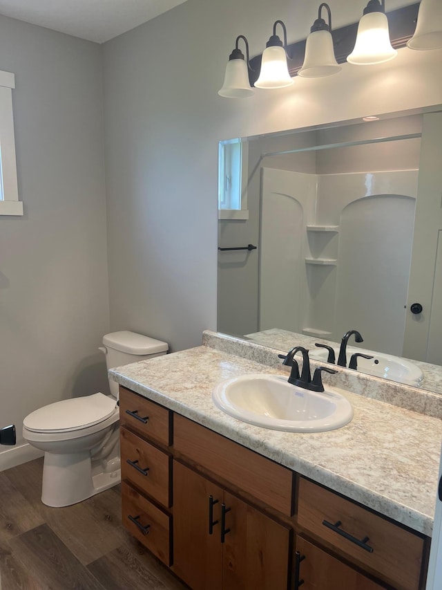 bathroom with vanity, hardwood / wood-style floors, and toilet