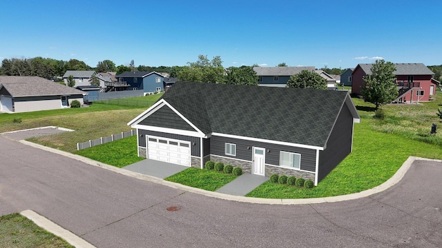 view of front of home featuring stone siding, a residential view, and a front yard