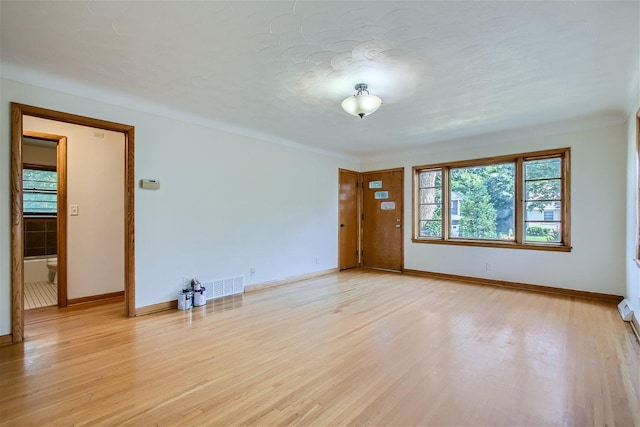 spare room with light wood-type flooring