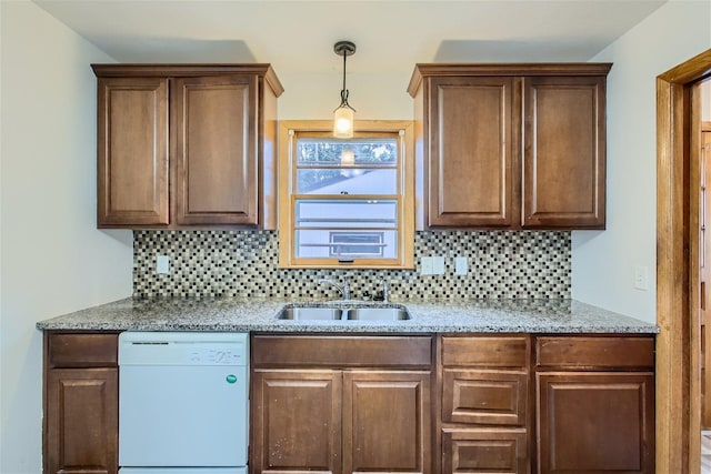 kitchen featuring sink, dishwasher, pendant lighting, and backsplash