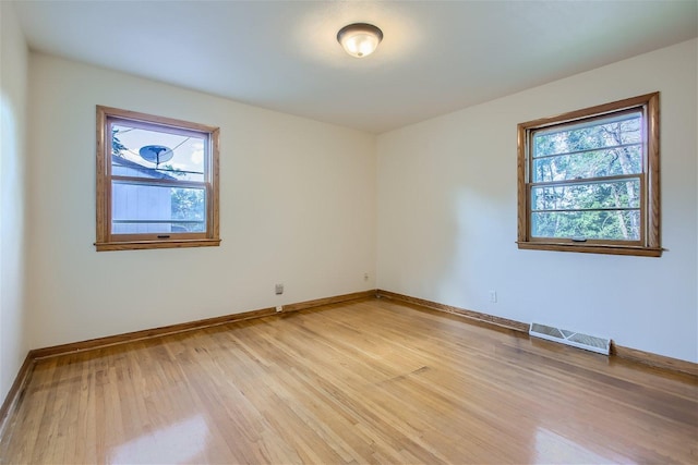 spare room with wood-type flooring