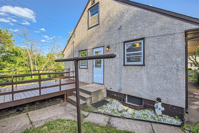 back of house featuring a deck