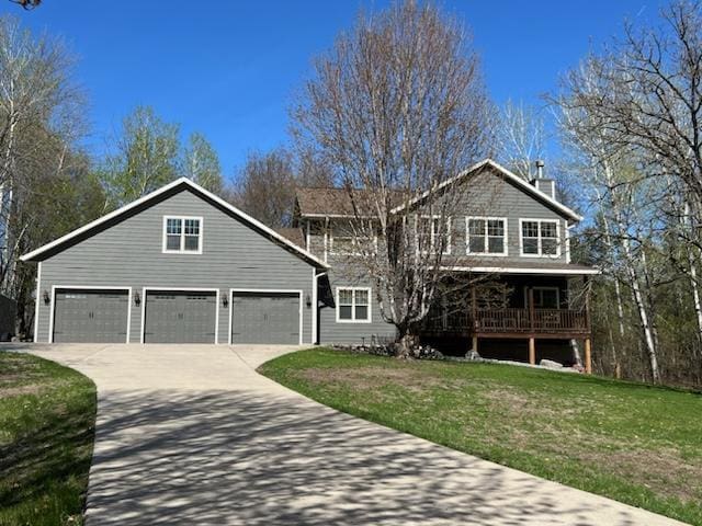 view of property with a garage and a front lawn