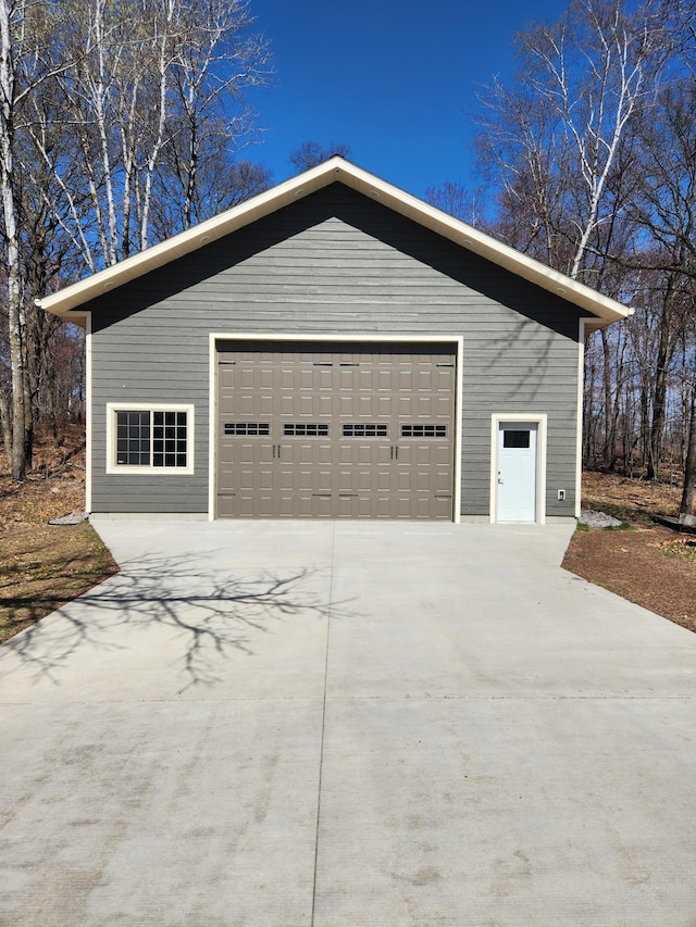 view of side of property with a garage and an outbuilding