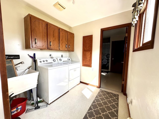 washroom featuring cabinet space, independent washer and dryer, and baseboards