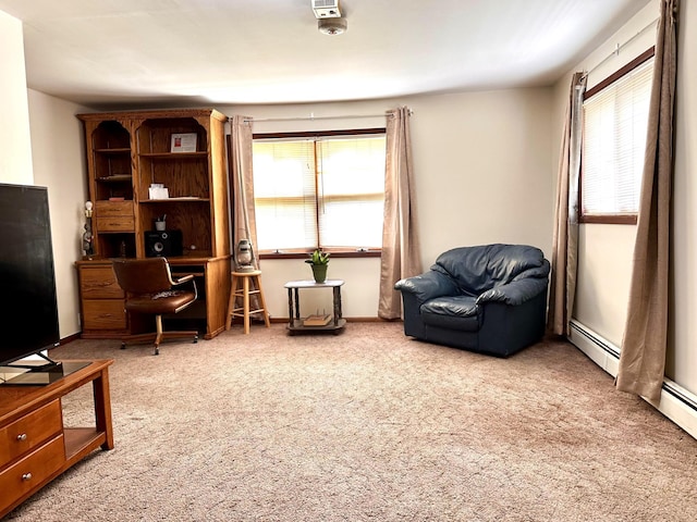 sitting room featuring carpet floors, baseboards, baseboard heating, and a wealth of natural light