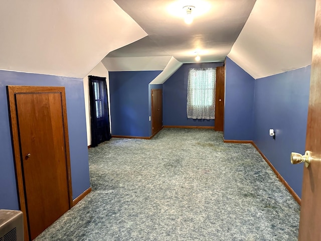 additional living space featuring lofted ceiling, carpet floors, and baseboards