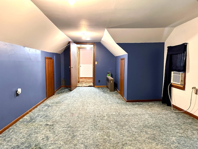 additional living space with lofted ceiling, carpet, cooling unit, and baseboards