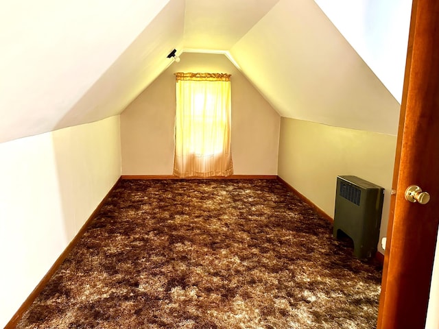 bonus room with vaulted ceiling, carpet, baseboards, and radiator