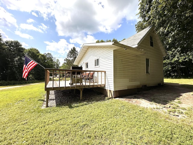 view of side of home with a lawn and a wooden deck