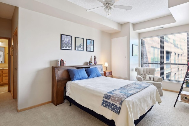 bedroom featuring visible vents, light carpet, a textured ceiling, and baseboards